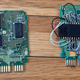 A factory-fresh Super Nintendo game board (left) and one that’s been altered to put a different game on it (right). You’re not going to see that rat’s nest of hand-soldered wires on any official Nintendo game.
